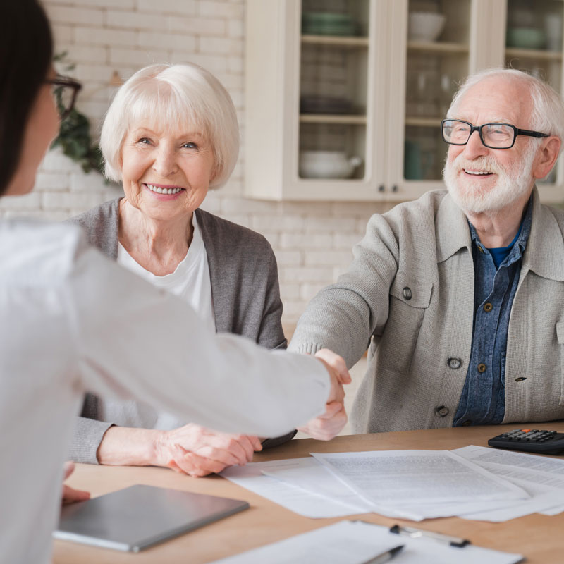 elderly couple with loan advisor