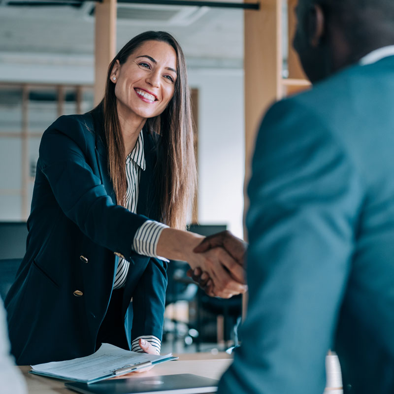 woman shaking hands with a man